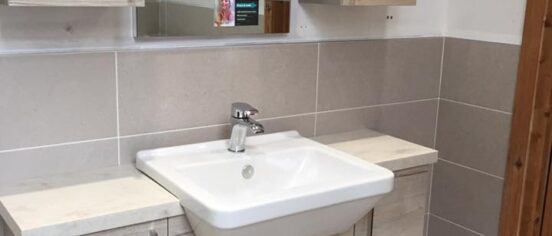 sink with cabinets and mirror